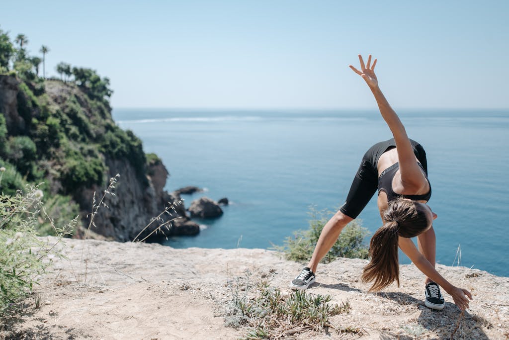 Woman in Black Sports Bra Doing Bending and Stretching Exercise 