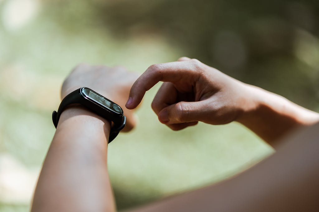 person using smart watch outdoors