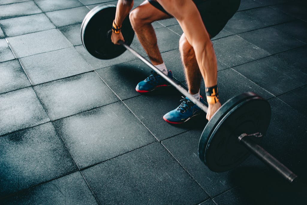 Person Holding Barbell Performance Enhancing Supplements 