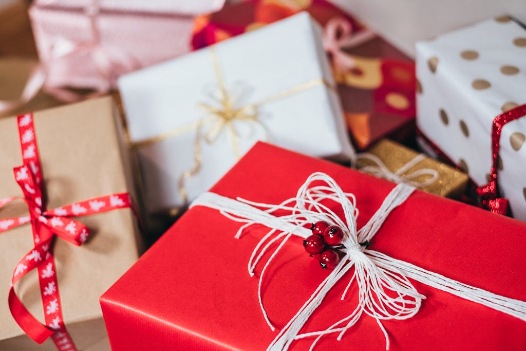 Close-up of festively wrapped Christmas biohacking gifts with ribbons and bows.