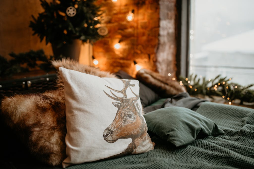 Warm and inviting bedroom featuring festive decor and a deer pillow on a bed.