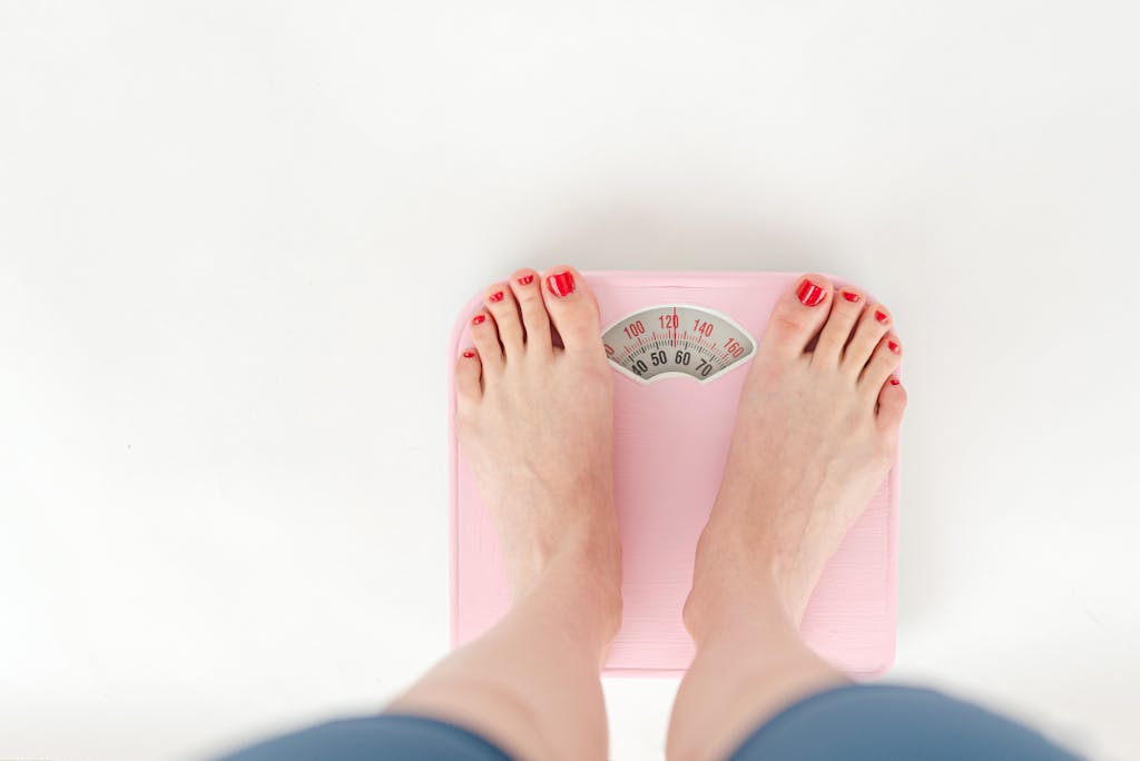 Best Nootropic Supplements for Weight Loss female measuring weight loss on scales on white background